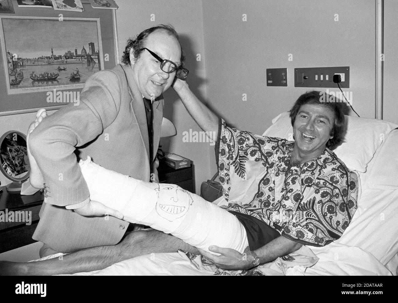 File photo dated 27/02/78 of veteran entertainer Des O'Connor (right) with Eric Morecambe, in the Wellington Hospital, London. Des O'Connor, who sadly passed away on Saturday 14 November aged 88. His agent confirmed he had been admitted to hospital just over a week ago, following a fall at his home in Buckinghamshire. Unfortunately yesterday evening his condition suddenly deteriorated and he drifted peacefully away in his sleep. Stock Photo