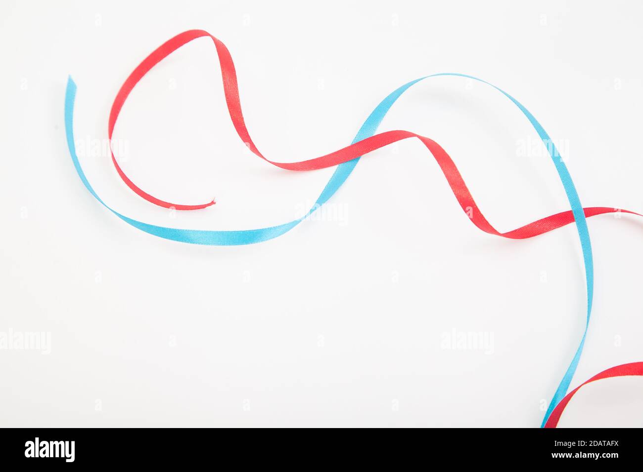 Interweaving red and blue wavy ribbons on white with copy space Stock ...