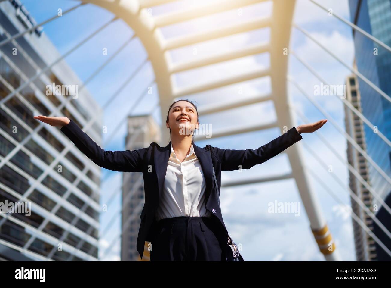 successful business woman with arms raised in the city Stock Photo - Alamy
