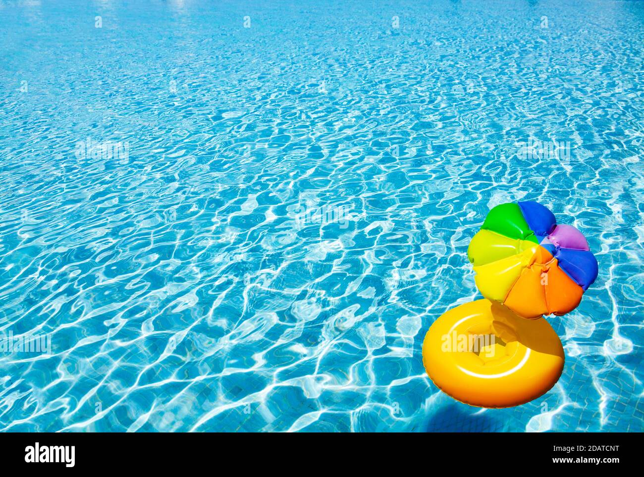 Inflatable yellow sun umbrella buoy swim in the swimming pool view with