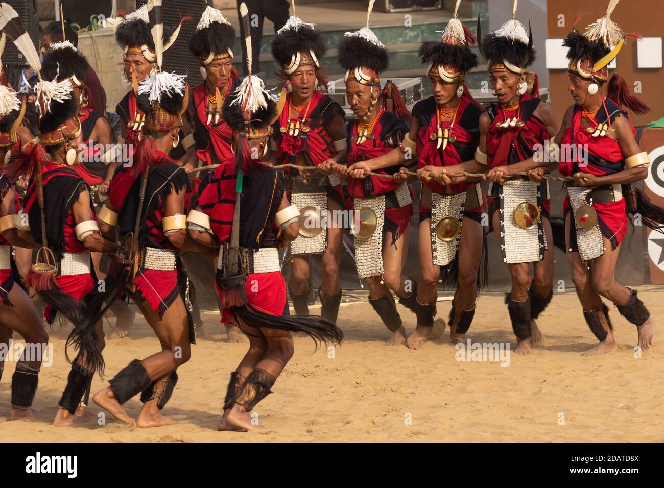 Naga tribesmen dressed in traditional attire performing traditional dance during Hornbill festival in Nagaland India on 4 December 2016 Stock Photo