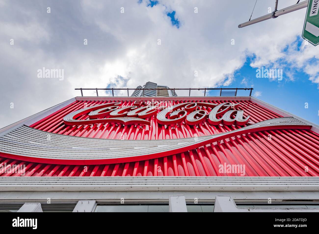 A daytime close up of the giant Coca Cola billboard sign at the top of William Street in Kings Cross, Sydney was erected in 1971 and refurbed in 2016 Stock Photo