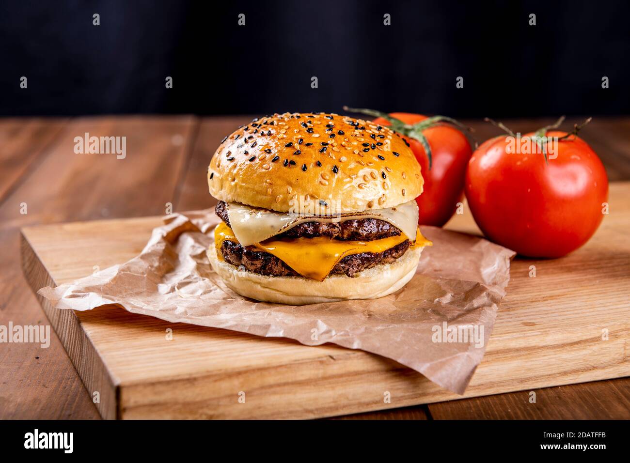 Hamburger served with two tomatoes Stock Photo