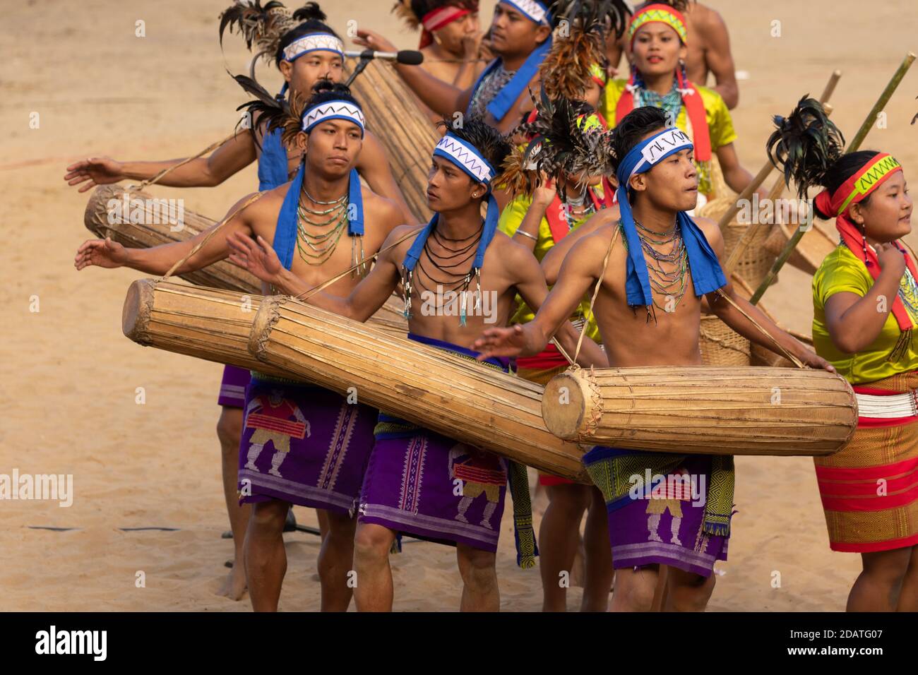Group of naga tribesmen and women  dressed in their traditional attire dancing during Hornbill festival in Nagaland India on 3 December 2016 Stock Photo