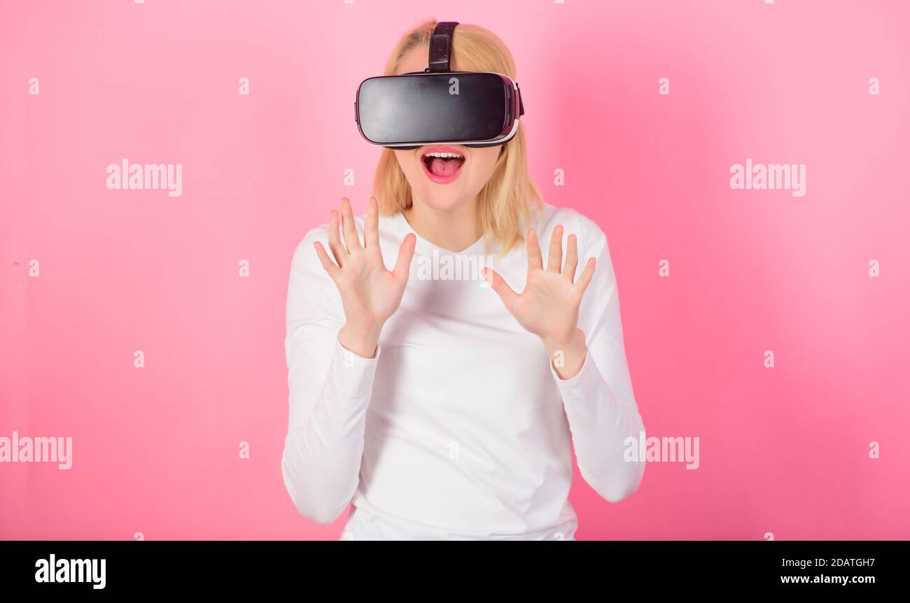 Woman using VR device. Woman watching virtual reality vision. 3d technology, virtual reality, entertainment, cyberspace and people concept. Adult VR Stock Photo