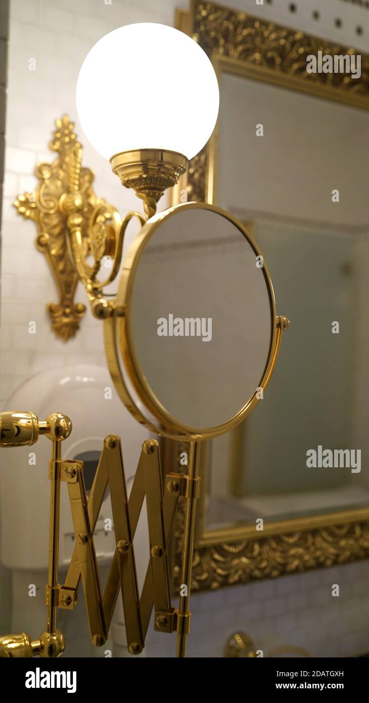 Bathroom mirror. Golden mirror Rack with bathroom mirror. Rich interior in the bathroom Stock