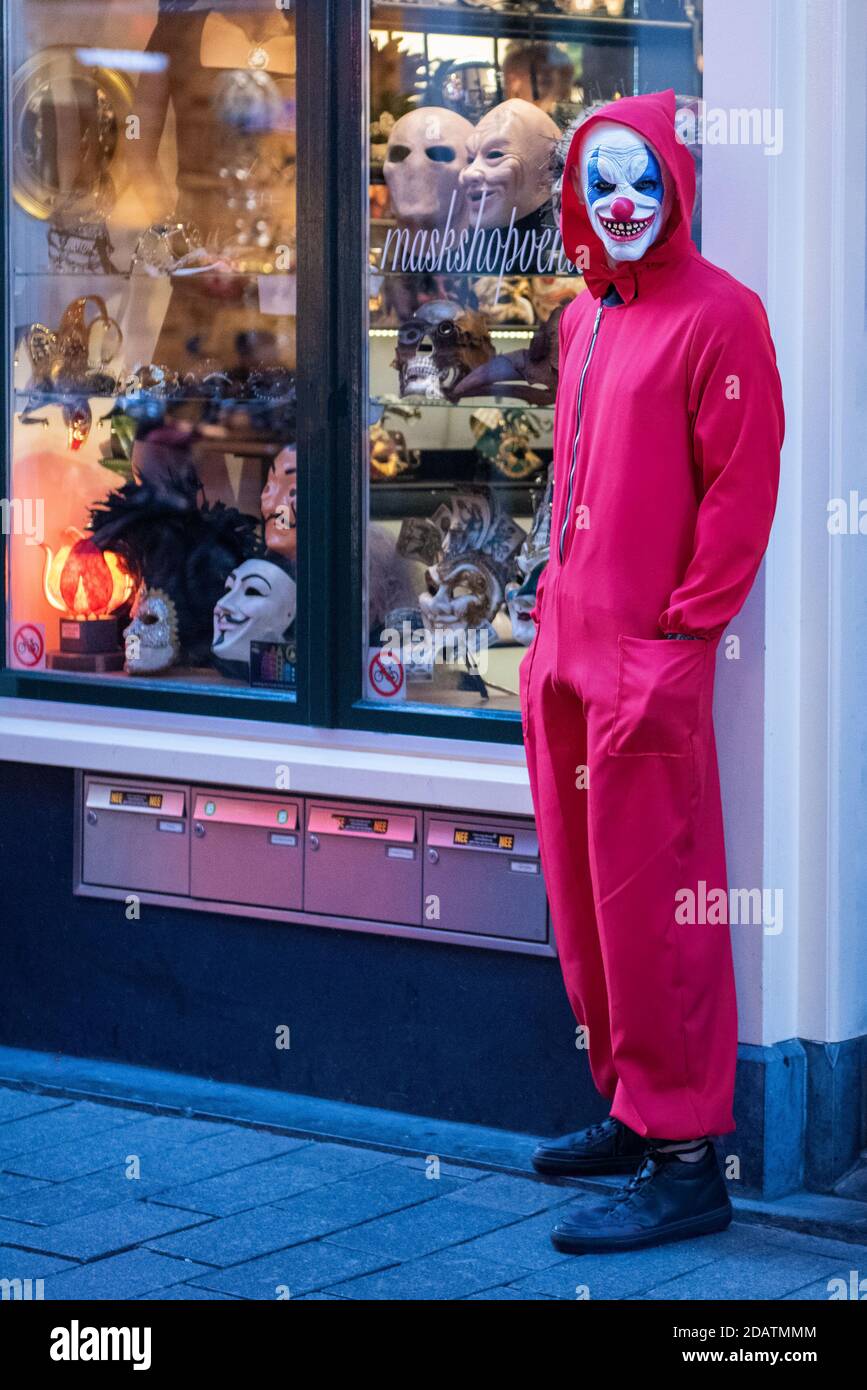 Life like, evil looking mannequin by the door of a shop selling masks in Amsterdam. Clown / Joker Stock Photo