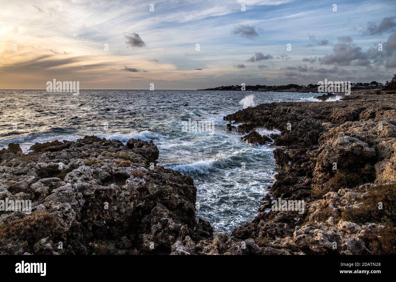 Landscape of waves tossing in the rocks in Italy during sunset Stock ...