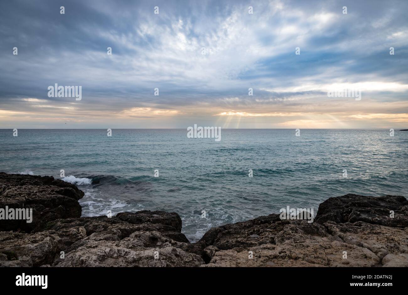 Landscape of waves tossing in the rocks in Italy during sunset Stock ...