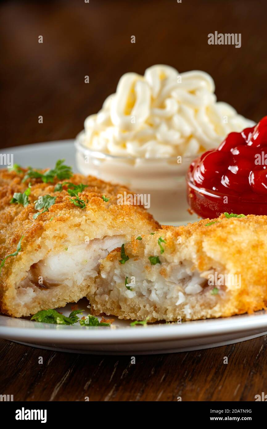 Fried fish with ketchup and mayonnaise sauce - close up view Stock Photo