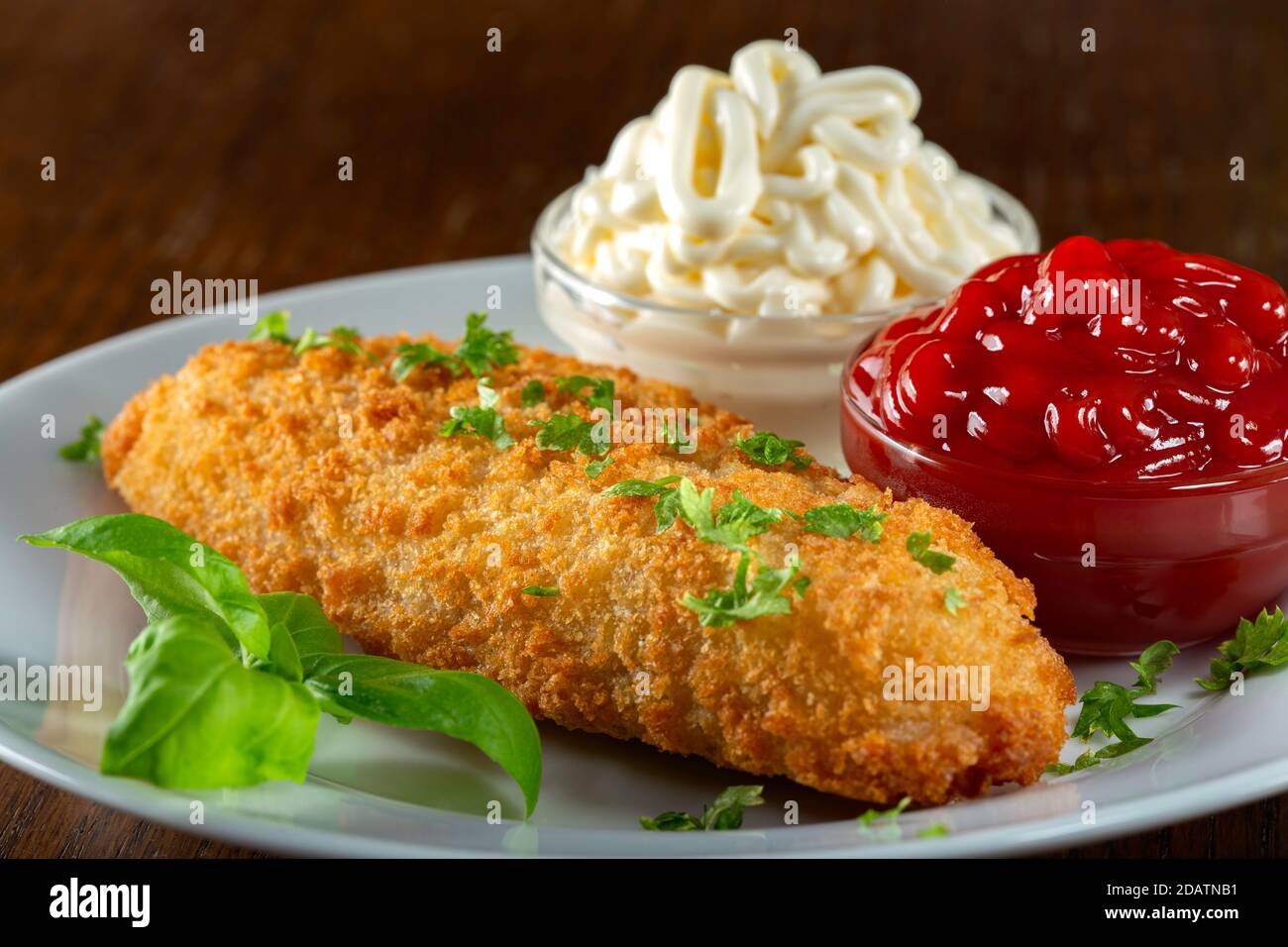 Fried fish with ketchup and mayonnaise sauce Stock Photo