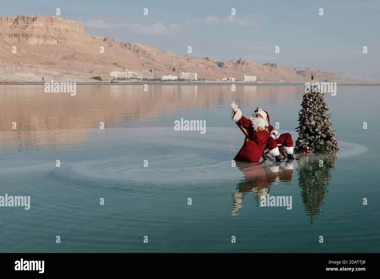 Neve Zohar, Israel. 15th Nov, 2020. Jerusalem Santa Claus ISSA KASSISSIEH relaxes on a salt mushroom in the Dead Sea, the lowest point on earth, ahead of a busy Christmas season. Kassissieh is taking part in the filming of a Christmas greeting video from Israel in a cooperation between the Ministry of Tourism and the Tamar Regional Council. Credit: Nir Alon/Alamy Live News Stock Photo