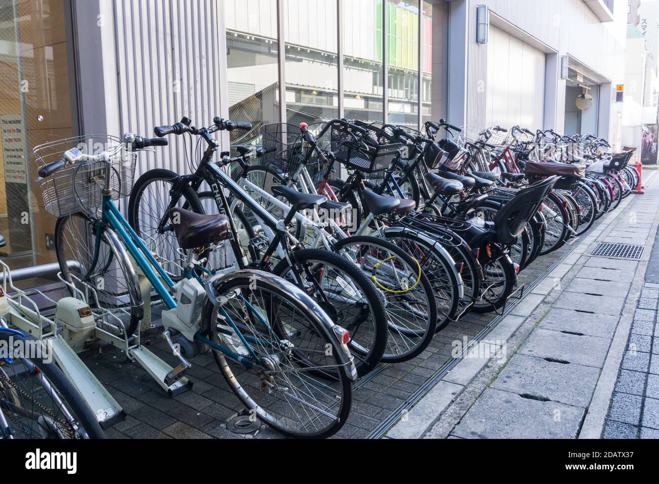 A rack of commuter bicycles at a parking area outside JR Nara Station, Nara, Japan Stock Photo