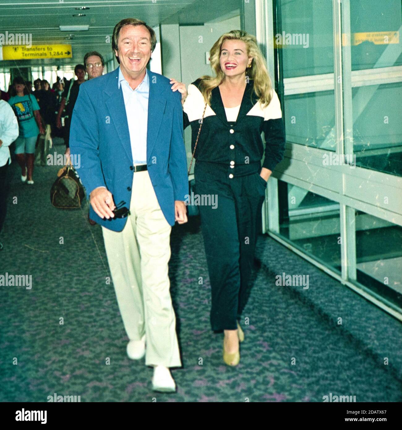 Des O'Connor with his wife Jodie Brooke Wilson at London Heathrow Airport 1992 Stock Photo