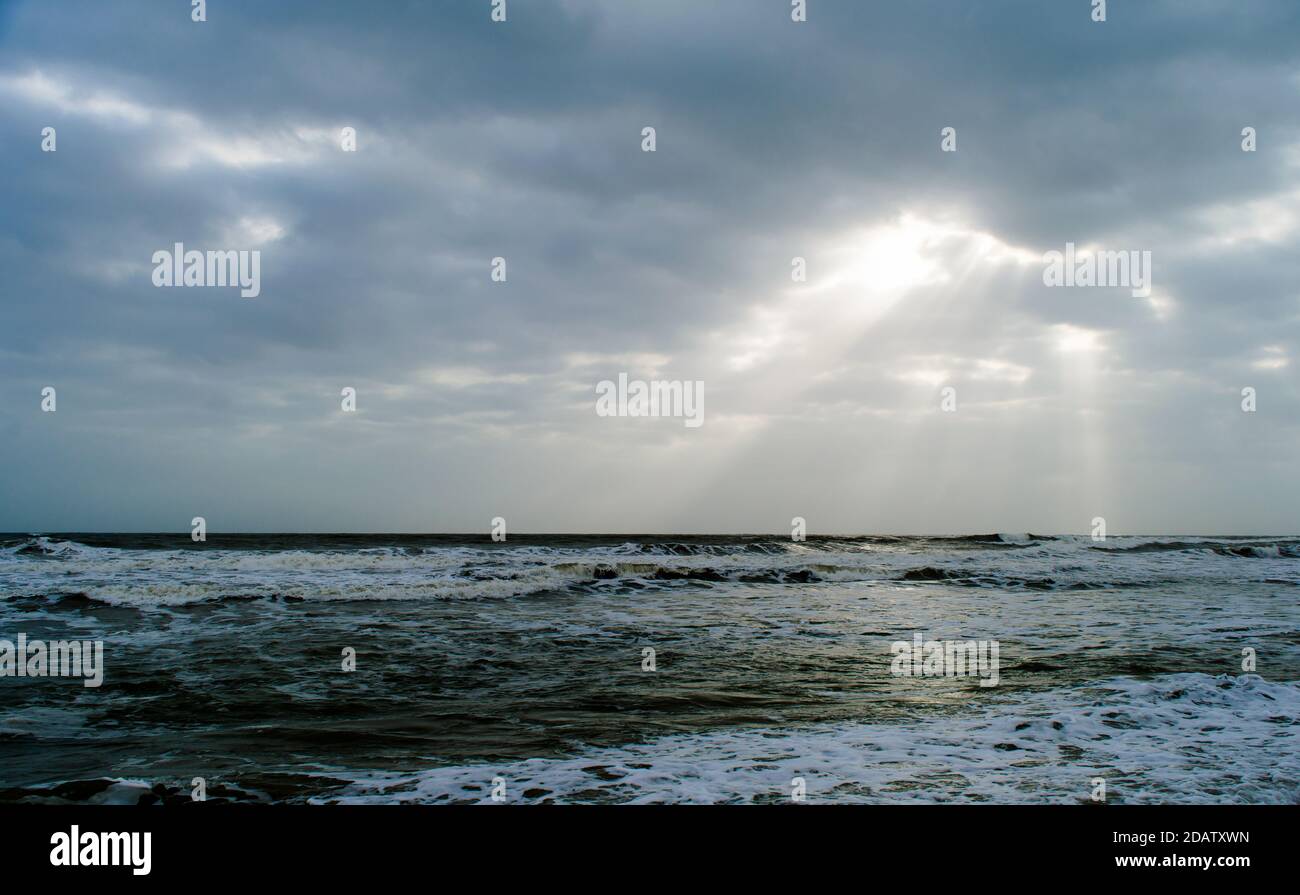 Sunshine pouring over the sea  through the clouds view from beach of somnath temple Gujarat India Stock Photo