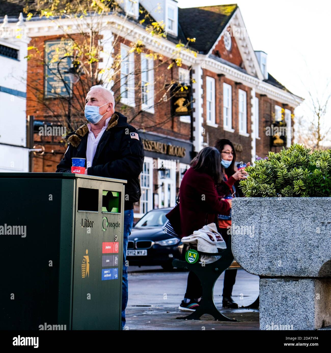 London UK, November 15 2020, Senior Man Standing Next To A Waste Bin With A Takeaway Coffee Hot Beverage Alone Stock Photo