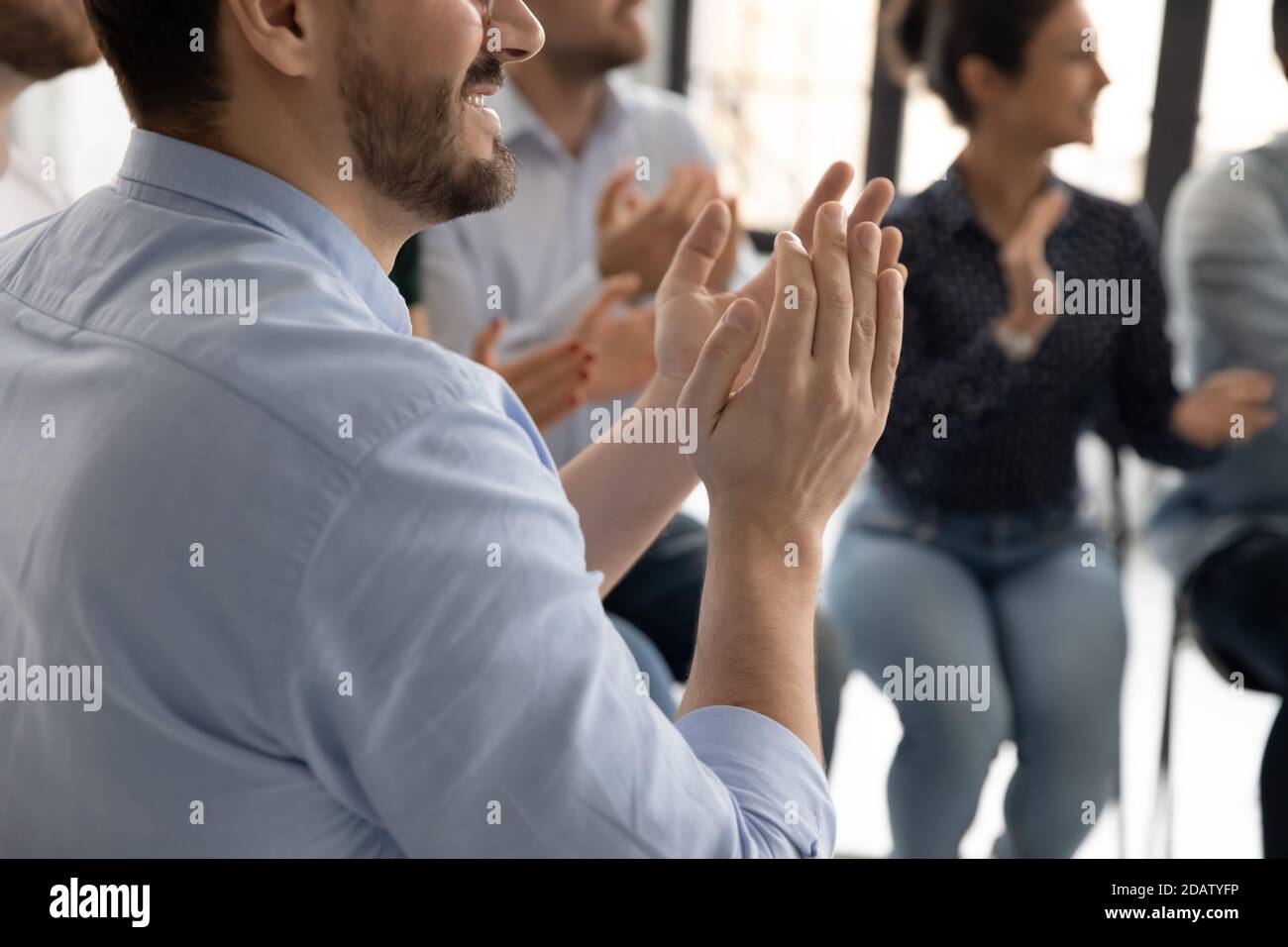 Multiethnic audience clapping hands appreciating lecturer for good speech Stock Photo
