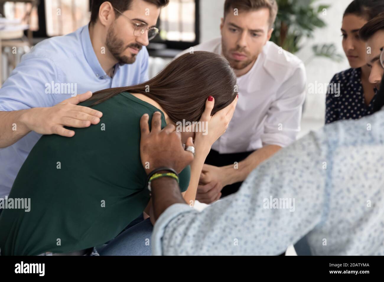 Crying millennial female having problems taking part in group therapy Stock Photo