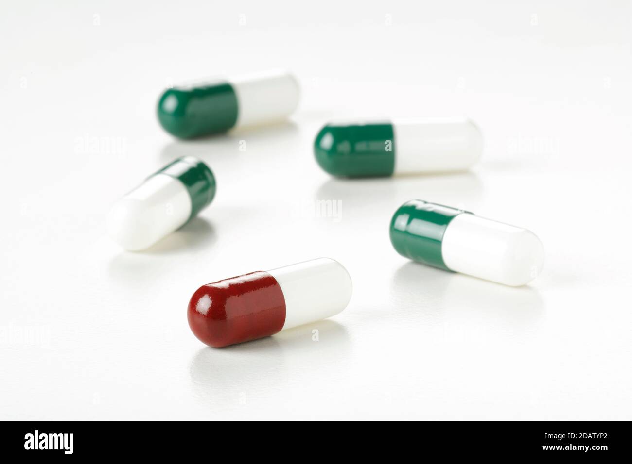 Medicinal pills seen up close, on white background, with shadows. Stock Photo