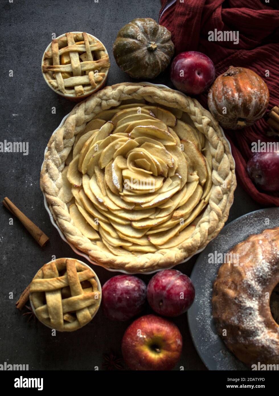 Dessert tarts on a table. Top view photo of various apple pies, cakes