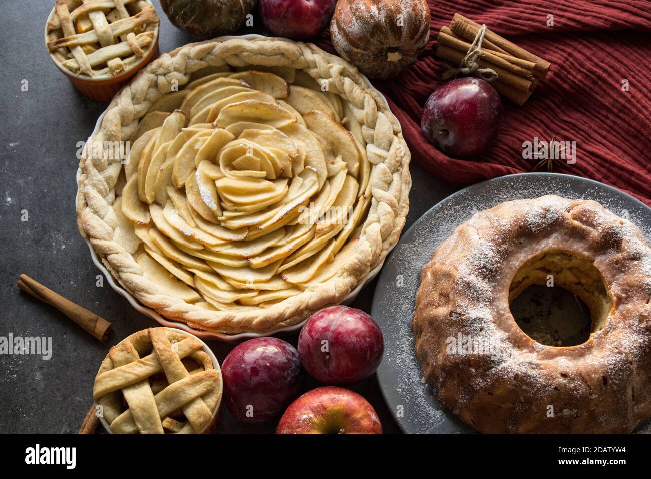 Dessert tarts on a table. Top view photo of various apple pies, cakes