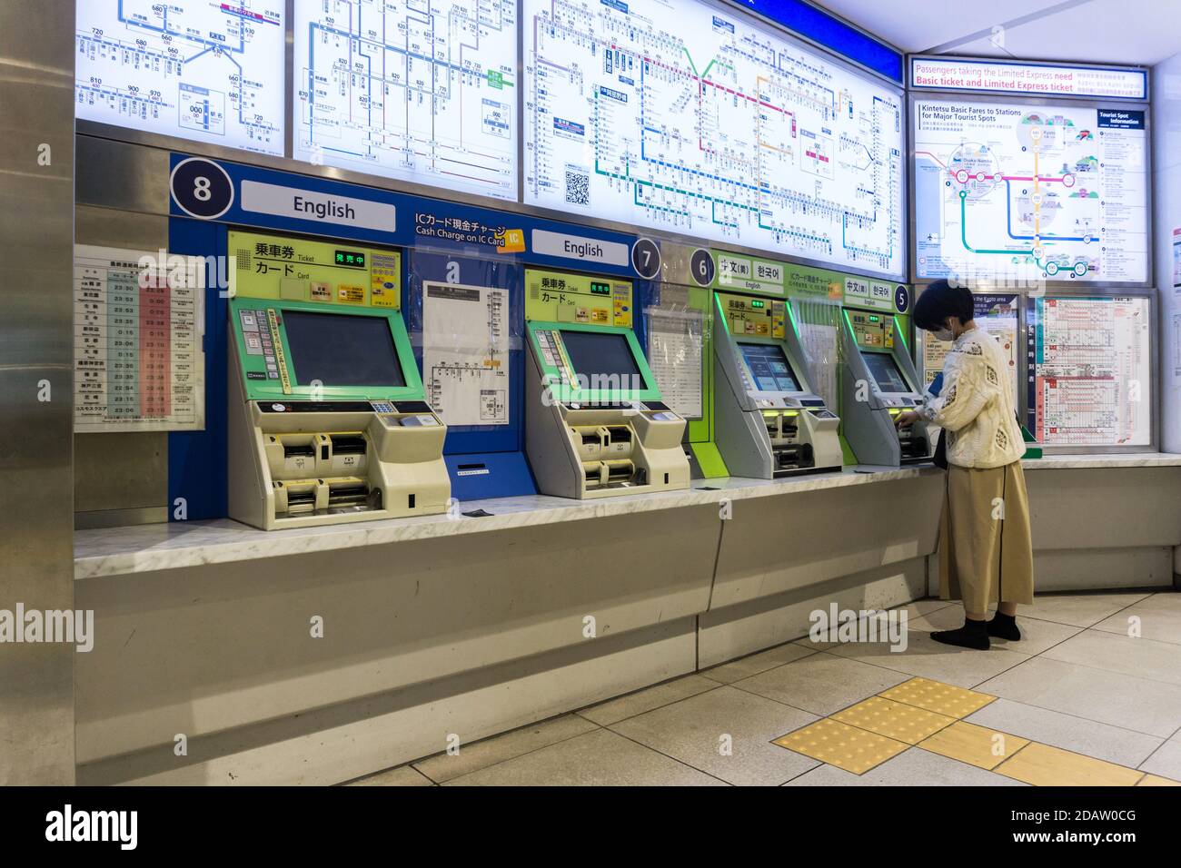 A woman buying a train ticket from railway ticket machines in Kintetsu Nara Station in Nara, Japan Stock Photo