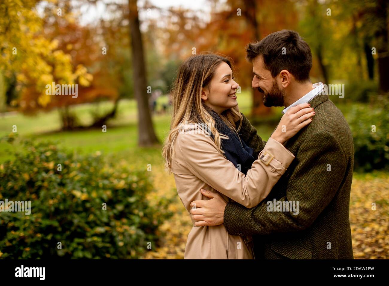 Handsome young couple walking in the autumn park Stock Photo - Alamy