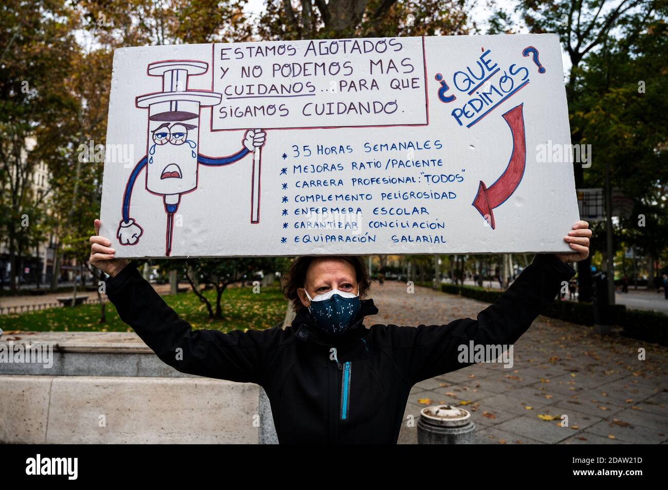 Madrid, Spain. 15th Nov, 2020. A nurse holds a placard showing nursing demands during a protest in front of the Healthcare Ministry where nurses are protesting demanding better working conditions and against the mistreatment of their sector during the Coronavirus (COVID-19) pandemic. Credit: Marcos del Mazo/Alamy Live News Stock Photo