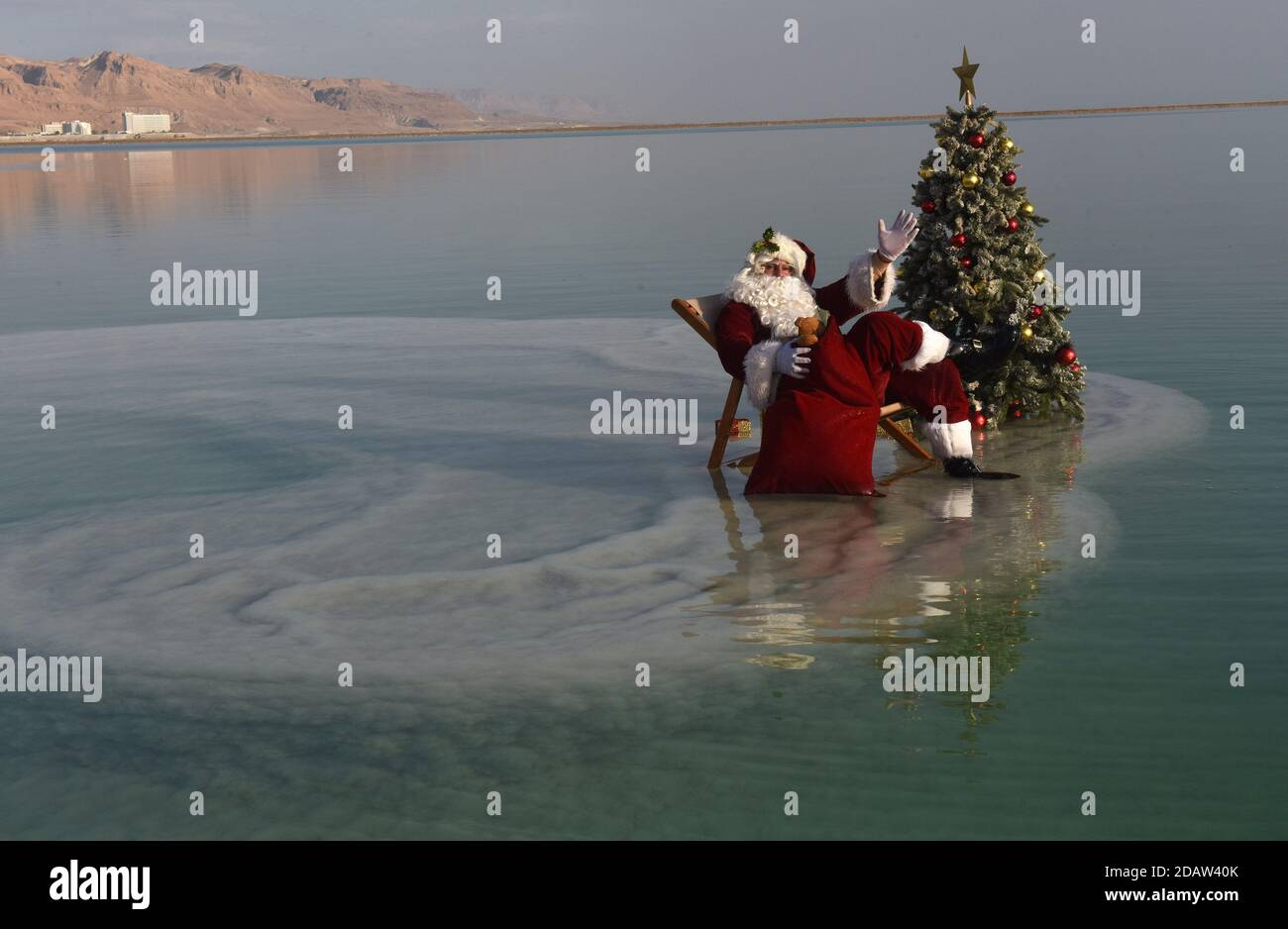 Ein Bokek, Israel. 15th Nov, 2020. Jerusalem Santa Issa Kassissieh relaxes on a salt formation in the Dead Sea, the lowest place earth, in Ein Bokek, Israel on Sunday, November 15, 2020. The photo event was organized by the Israel Ministry of Tourism to encourage tourism to the Dead Sea ahead of the Christmas holiday. Incoming tourism to Israel has received a severe blow due to the global coronavirus pandemic and the closure to incoming tourists since March. Photo by Debbie Hill/UPI Credit: UPI/Alamy Live News Stock Photo