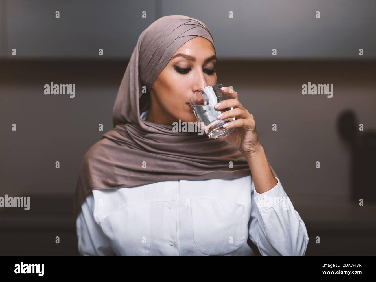 Woman in hijab drinking water hi-res stock photography and images - Alamy
