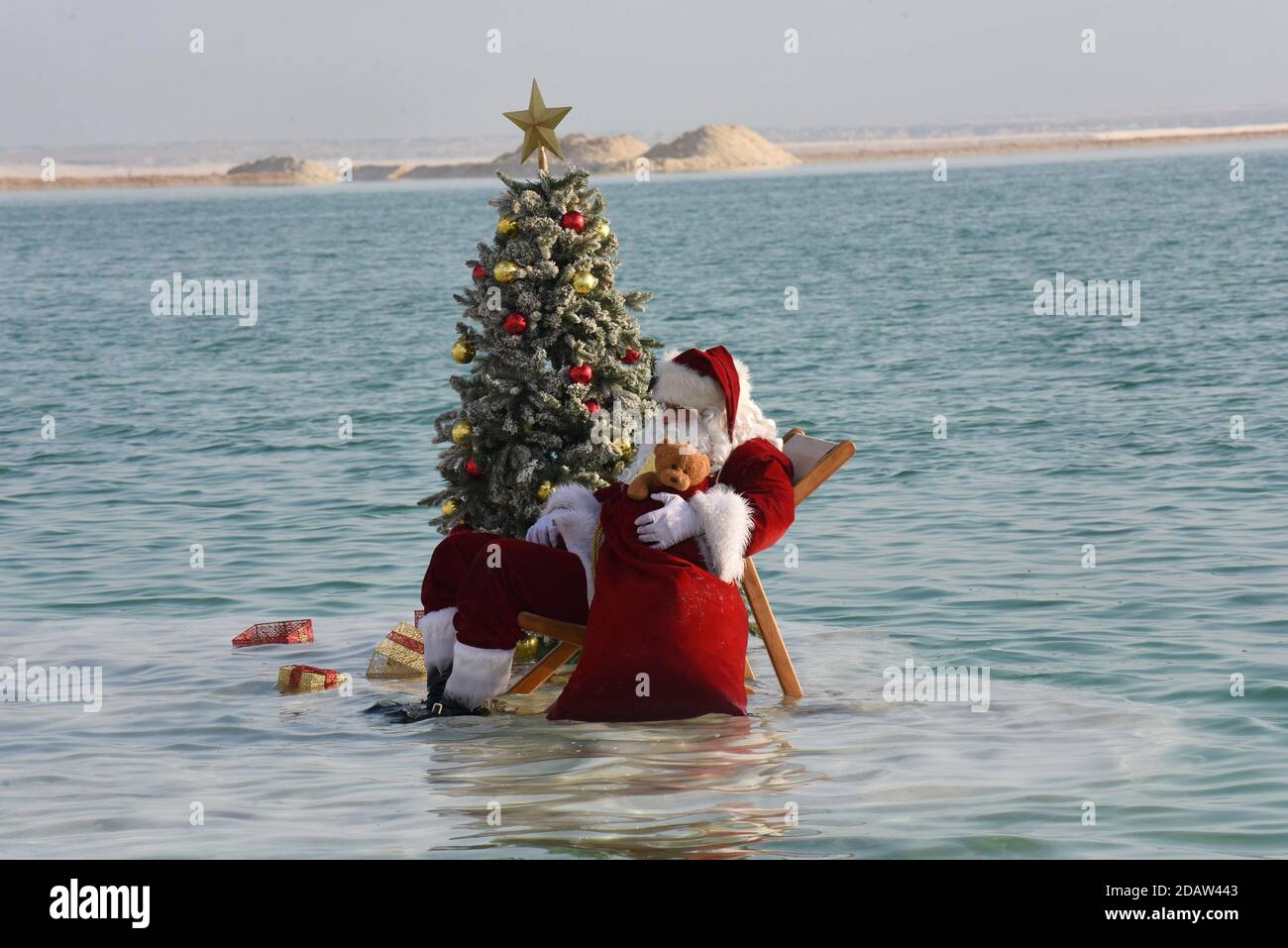 Ein Bokek, Israel. 15th Nov, 2020. Jerusalem Santa Issa Kassissieh relaxes on a salt formation in the Dead Sea, the lowest place earth, in Ein Bokek, Israel on Sunday, November 15, 2020. The photo event was organized by the Israel Ministry of Tourism to encourage tourism to the Dead Sea ahead of the Christmas holiday. Incoming tourism to Israel has received a severe blow due to the global coronavirus pandemic and the closure to incoming tourists since March. Photo by Debbie Hill/UPI Credit: UPI/Alamy Live News Stock Photo