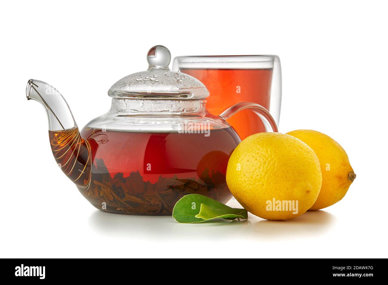 Cup and teapot of black tea with lemon isolated on white Close up Stock