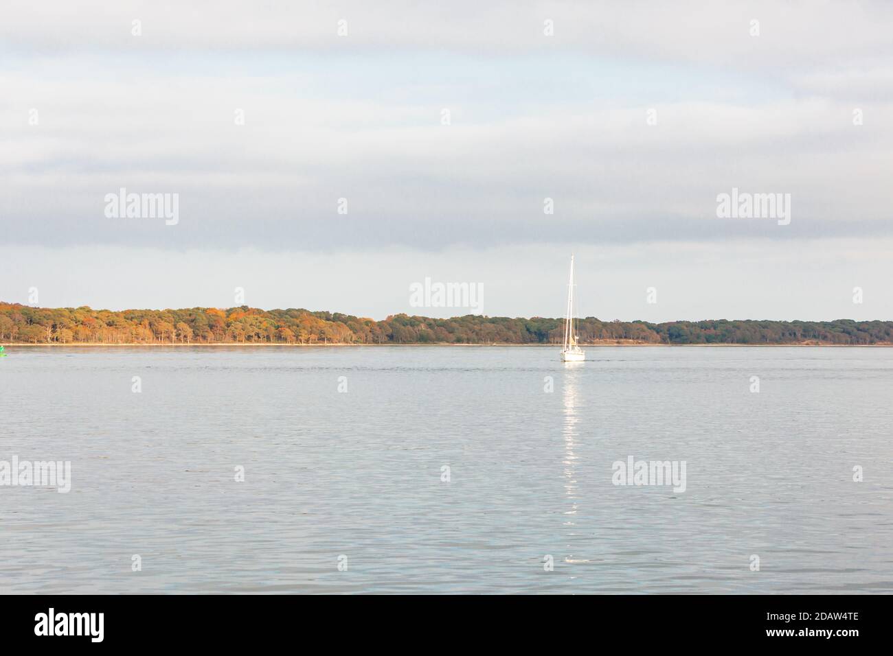 Sail boat motoring on a crisp fall afternoon just off Shelter Island, NY Stock Photo
