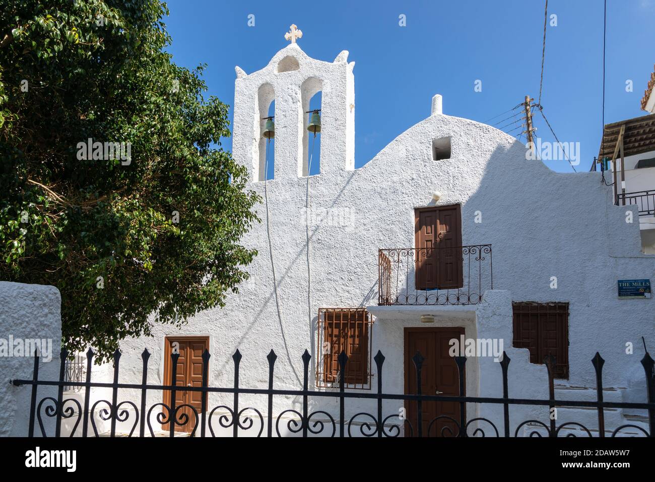 Chora, Ios Island, Greece- 20 September 2020: View of the church in the old town. The facade of the building and the characteristic belfry. Stock Photo