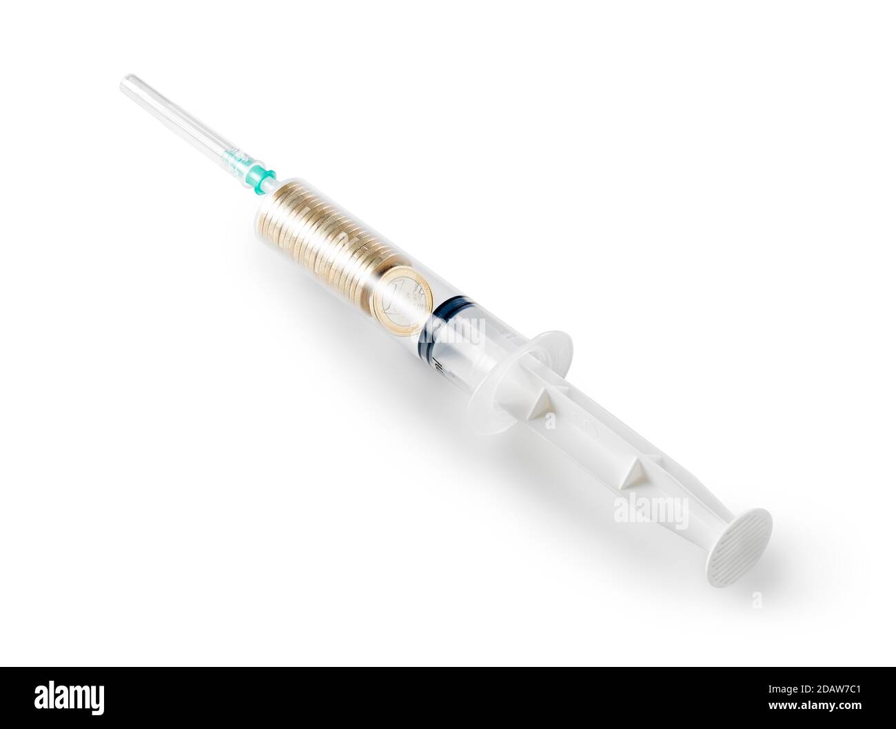 A syringe contains coins, on a white background, with shadows. Stock Photo