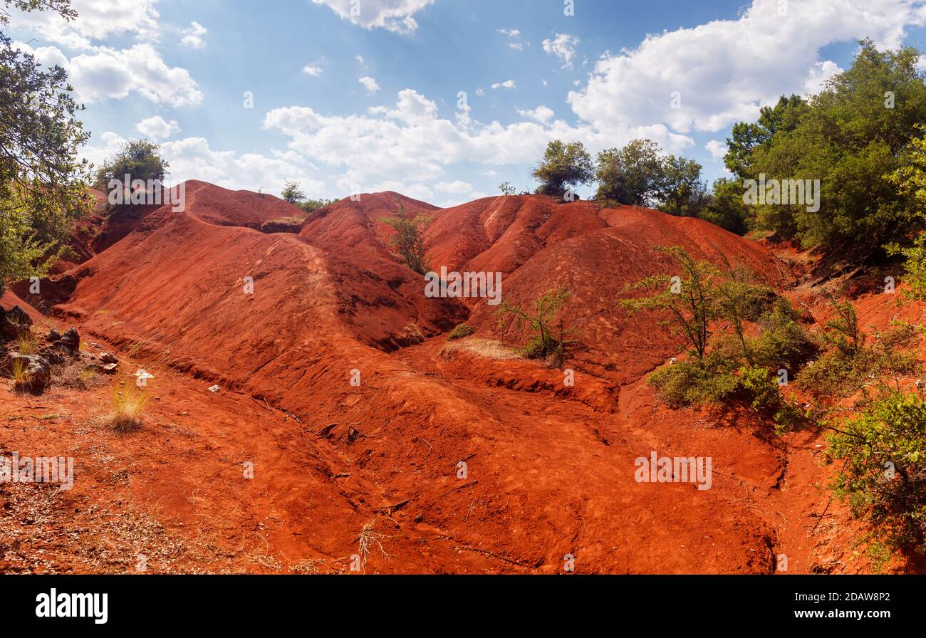 Red clay terrain at Kokkinopilos area, a rare geological phenomenon where a valley is entirely made of red clay soil, near Preveza, in Epirus, Greece. Stock Photo