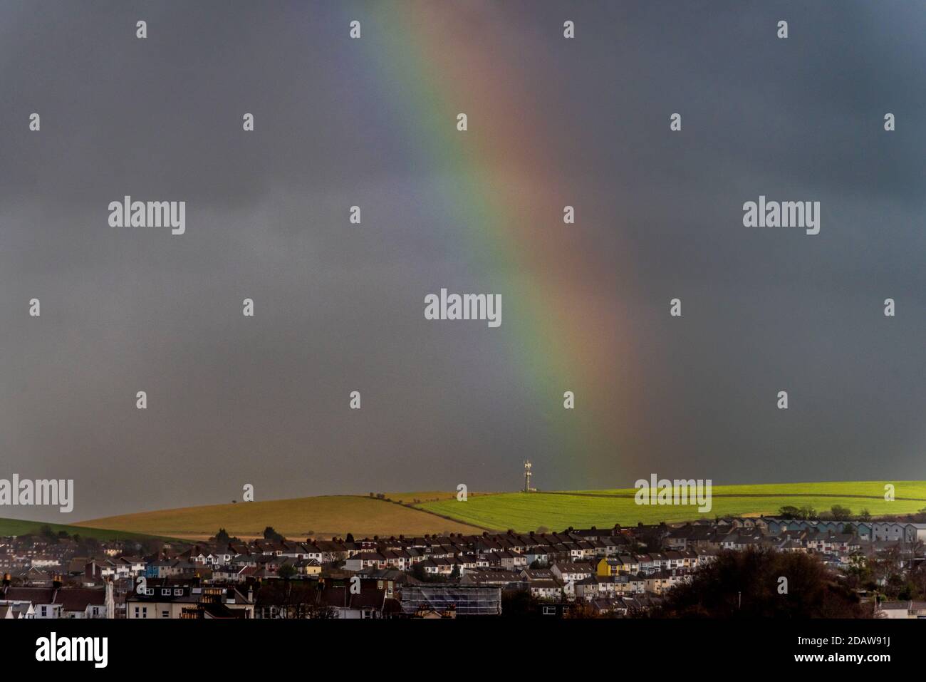 Brighton, November 15th 2020: Changeable weather conditions produced downpours, rainbows and unusual light in the streets of the city this afternoon Credit: Andrew Hasson/Alamy Live News Stock Photo