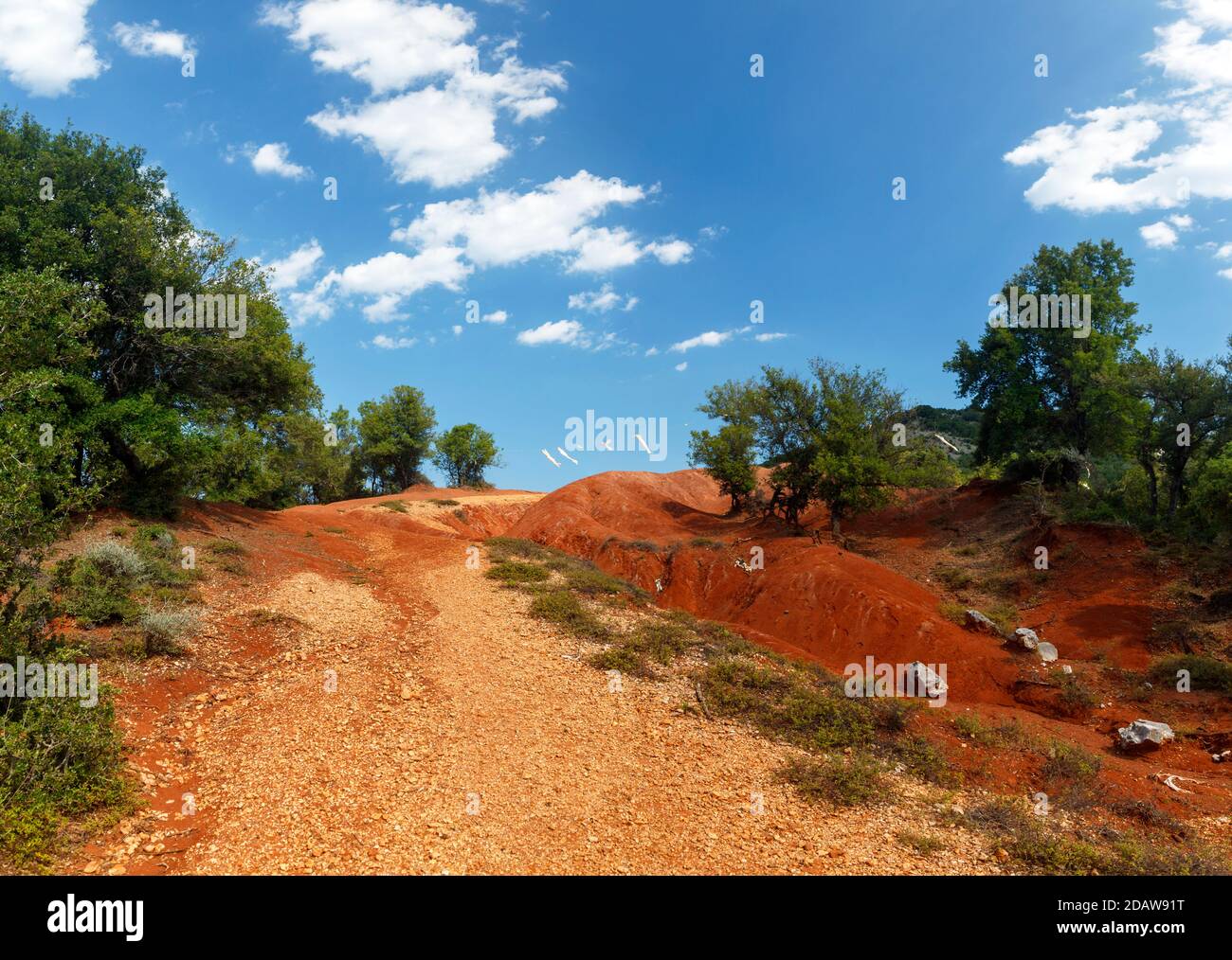 Red clay terrain at Kokkinopilos area, a rare geological phenomenon where a valley is entirely made of red clay soil, near Preveza, in Epirus, Greece, Stock Photo