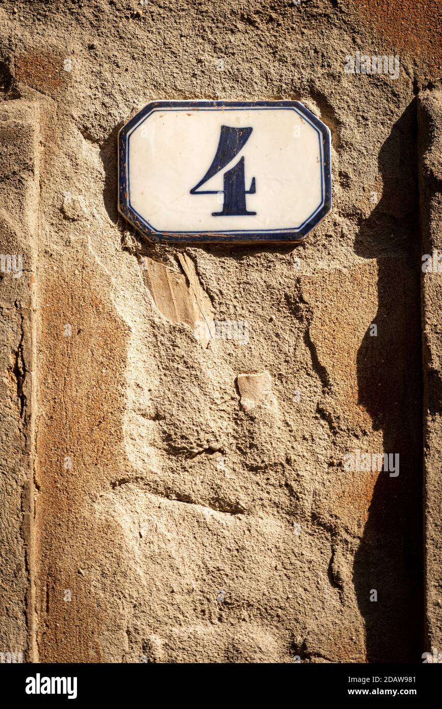 Close-up of house number 4 (four) on a broken wall, Verona city, Veneto, Italy, southern Europe. Stock Photo