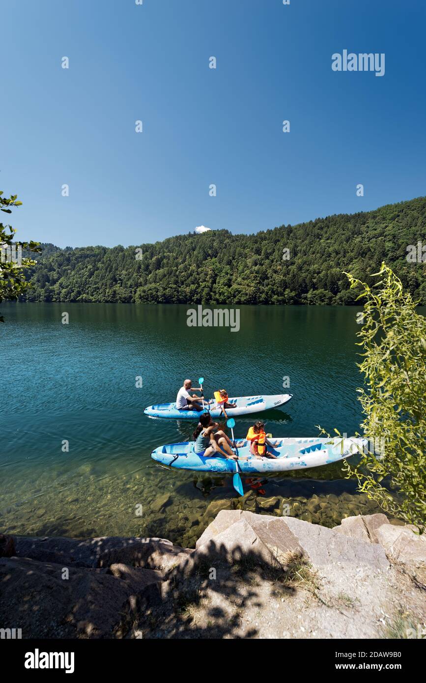 Family with two children on two kayaks in the beautiful Lake Levico in Valsugana (Sugana Valley), Trentino Alto Adige, Italy, Europe Stock Photo