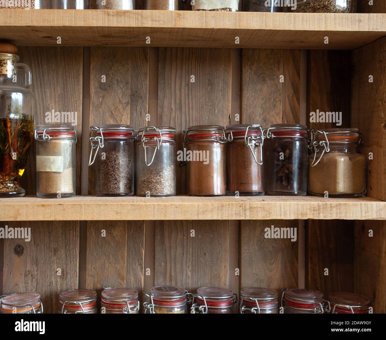 Glass jars with colored herbs and spices. Decoration bottles for kitchen  Stock Photo - Alamy