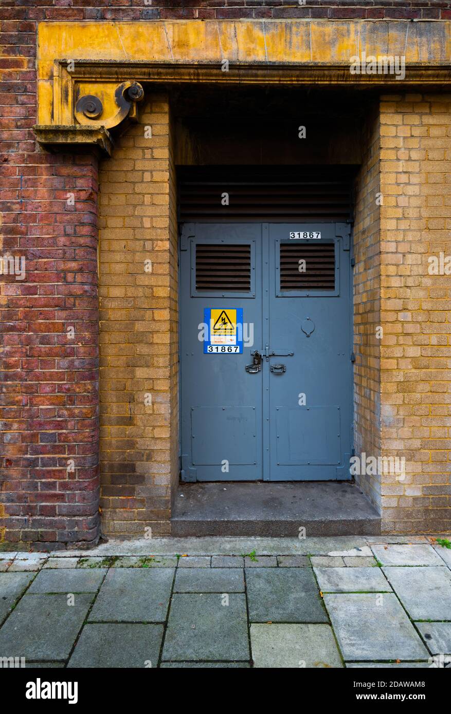 Blue works or engineering door to old brick building Stock Photo
