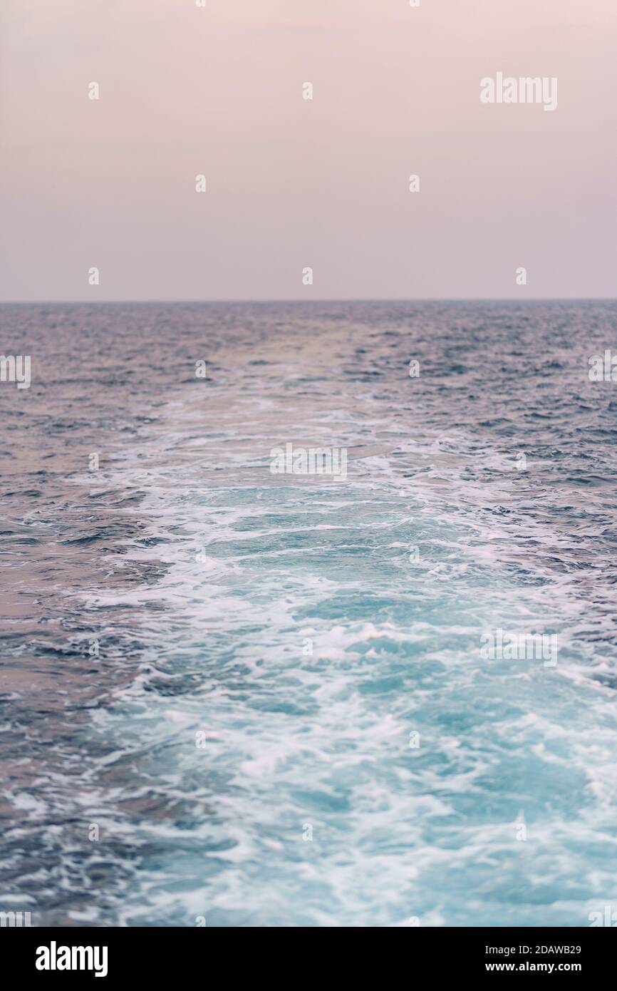 Water surface background. Blue sea water splashes with sun reflections. Ripples of water in the. Stock Photo