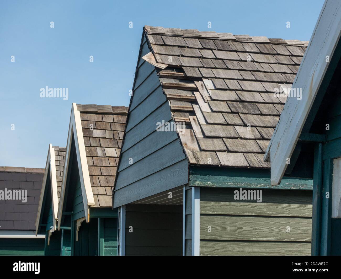 Beach hut roof tiles missing after coastal storm wind damage Stock Photo
