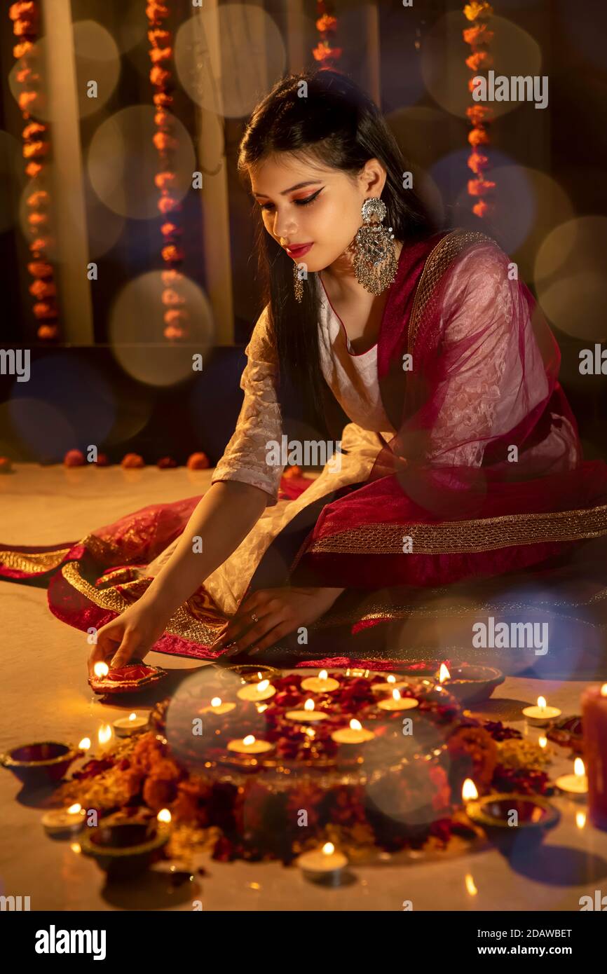 Dhaka, Bangladesh. 14th Nov, 2020. A woman poses for a photo with the lamps  on her hands to celebrate Diwali, the Hindu Festival of Lights, in Dhaka,  Bangladesh, on Nov. 14, 2020.