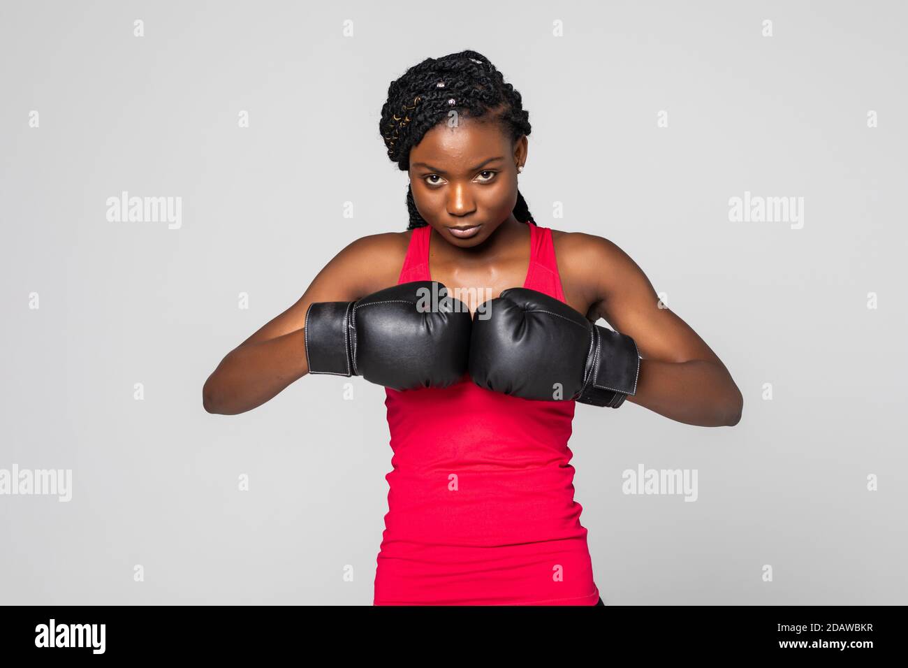 Girl champion. Portrait of beautiful black woman boxer in fighting gloves on  gray background Stock Photo - Alamy
