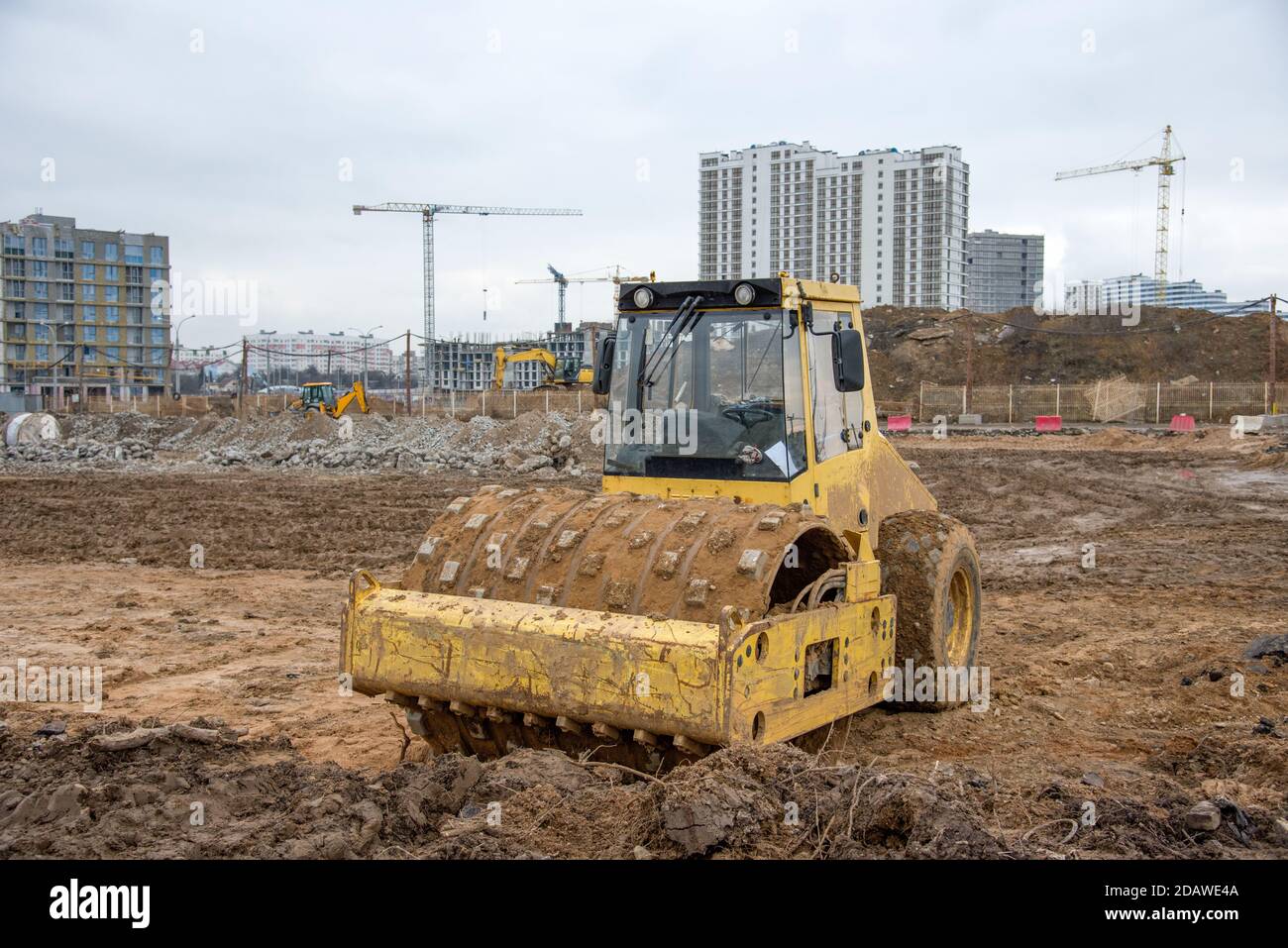 Soil Compactor at construction site. Vibration single-cylinder road roller for leveling soil, gravel, concrete, or asphalt in the construction of road Stock Photo