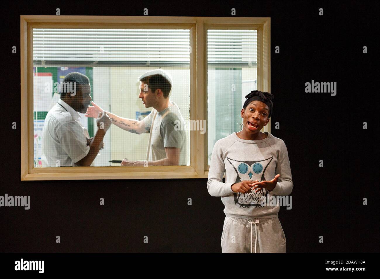 l-r: Danny Sapani (Security Guard), Toby Wharton (Tattoo Boy), Michaela Coel (Young Mum / Portugal) in HOME written & directed by Nadia Fall at The Shed, National Theatre (NT), London SE1  31/03/2014  design: Ruth Sutcliffe   lighting: Ciaran Bagnall Stock Photo