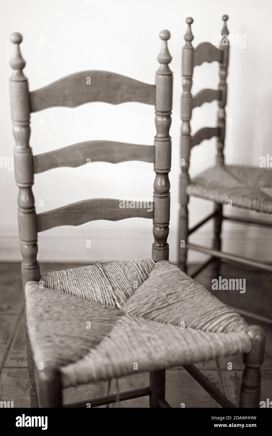 wooden and straw Súgán Irish chairs in kitchen Stock Photo
