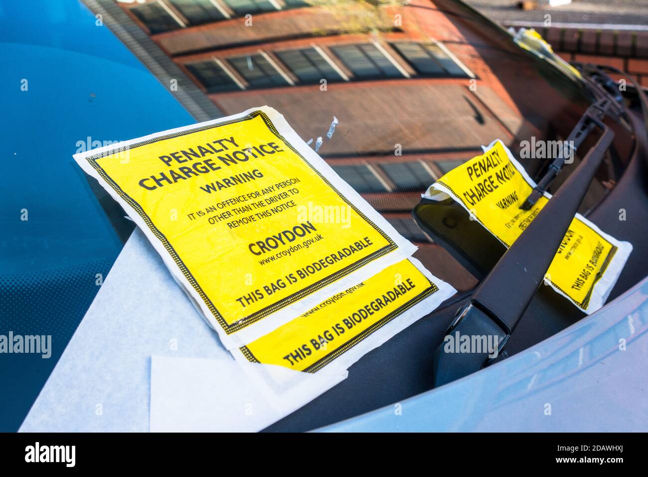 Multiple Penalty Charge Notice PCN slapped on a car front window in Croydon Council operated pay and display roadside parking Stock Photo